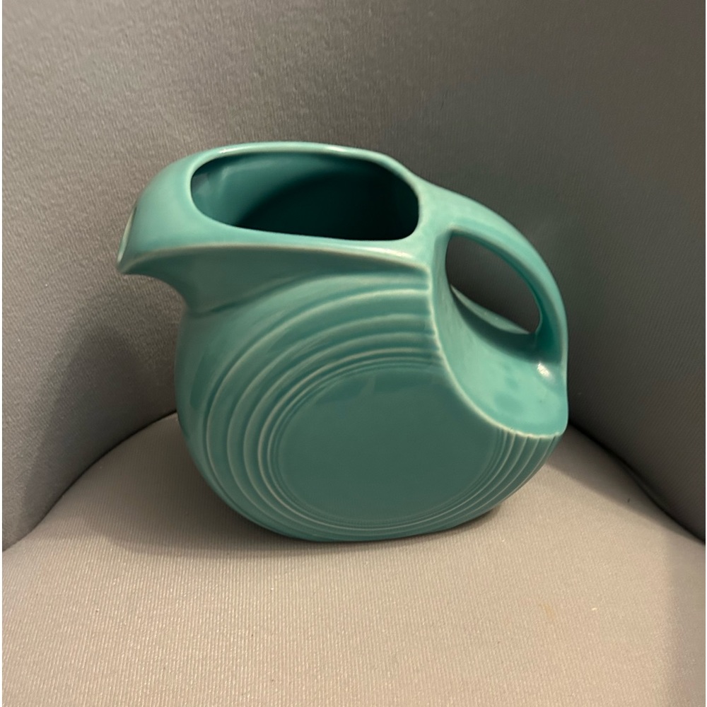 Large Turquoise Fiesta Ware Pitcher. 6 3/4” H x 8 1/2” W (Handle to Spout).